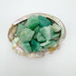 Close-up of Grade A Aventurine raw stone, showing natural banding.