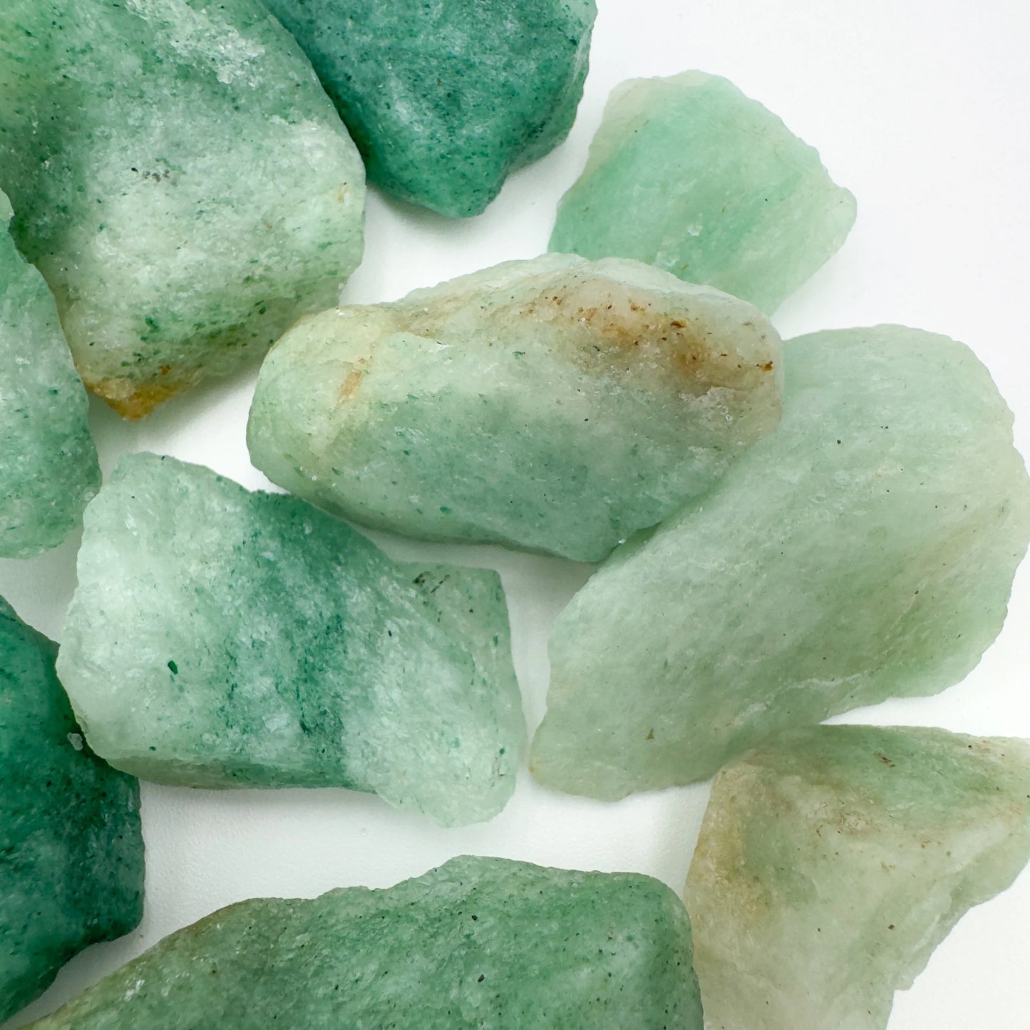 Hand-held view of a single Aventurine raw stone sourced from Zimbabwe.