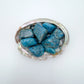 Color detail of Apatite tumbled stone, often kept for Focus and Manifestation, showing natural inclusions.