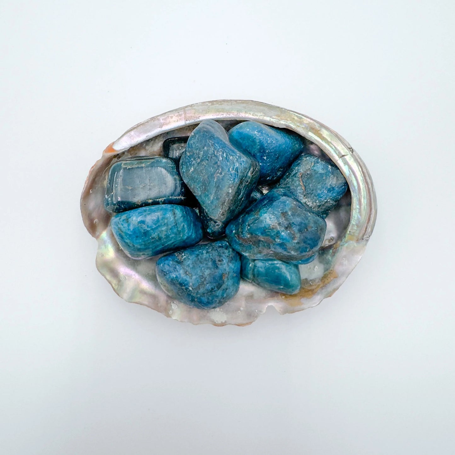 Color detail of Apatite tumbled stone, often kept for Focus and Manifestation, showing natural inclusions.
