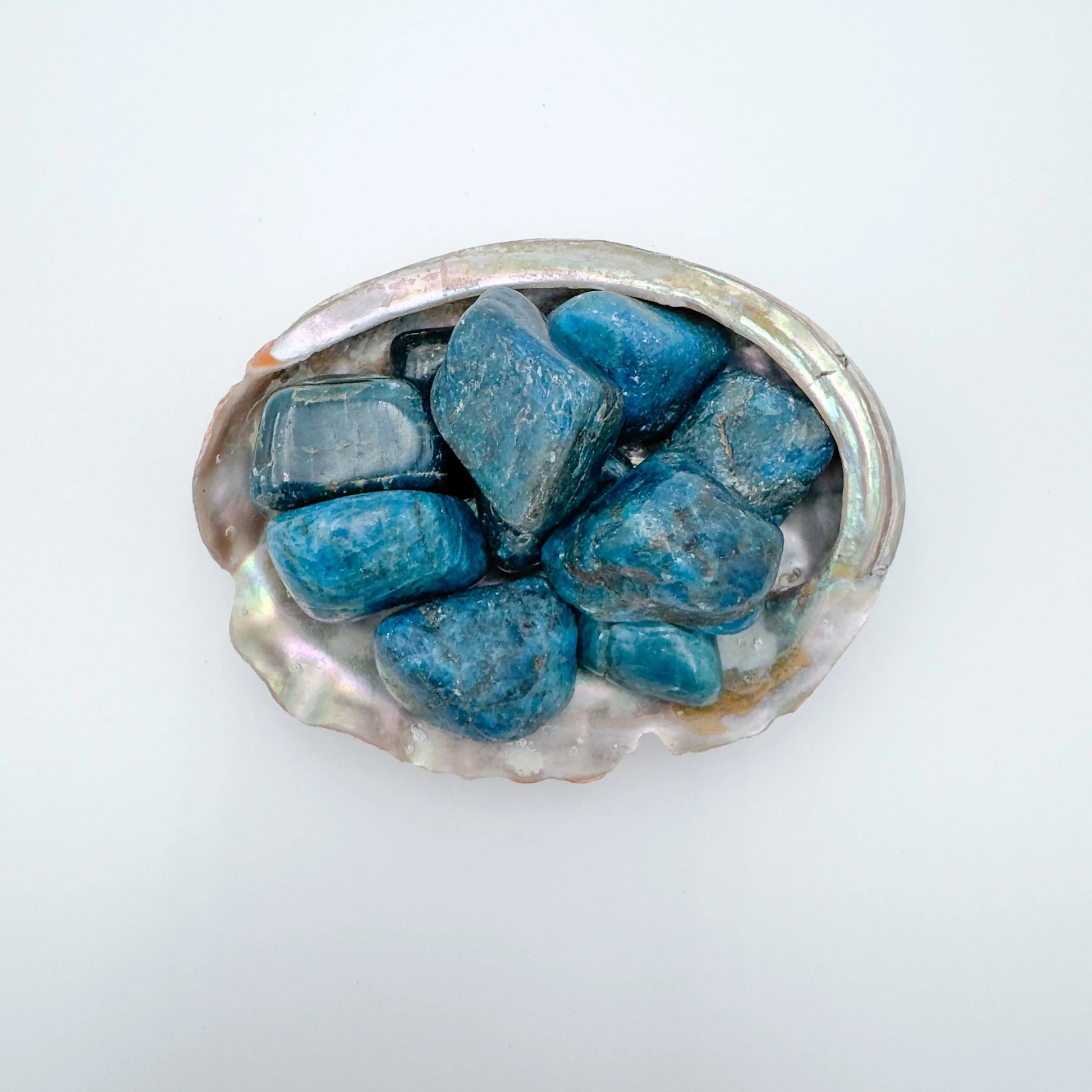 Color detail of Apatite tumbled stone, often kept for Focus and Manifestation, showing natural inclusions.