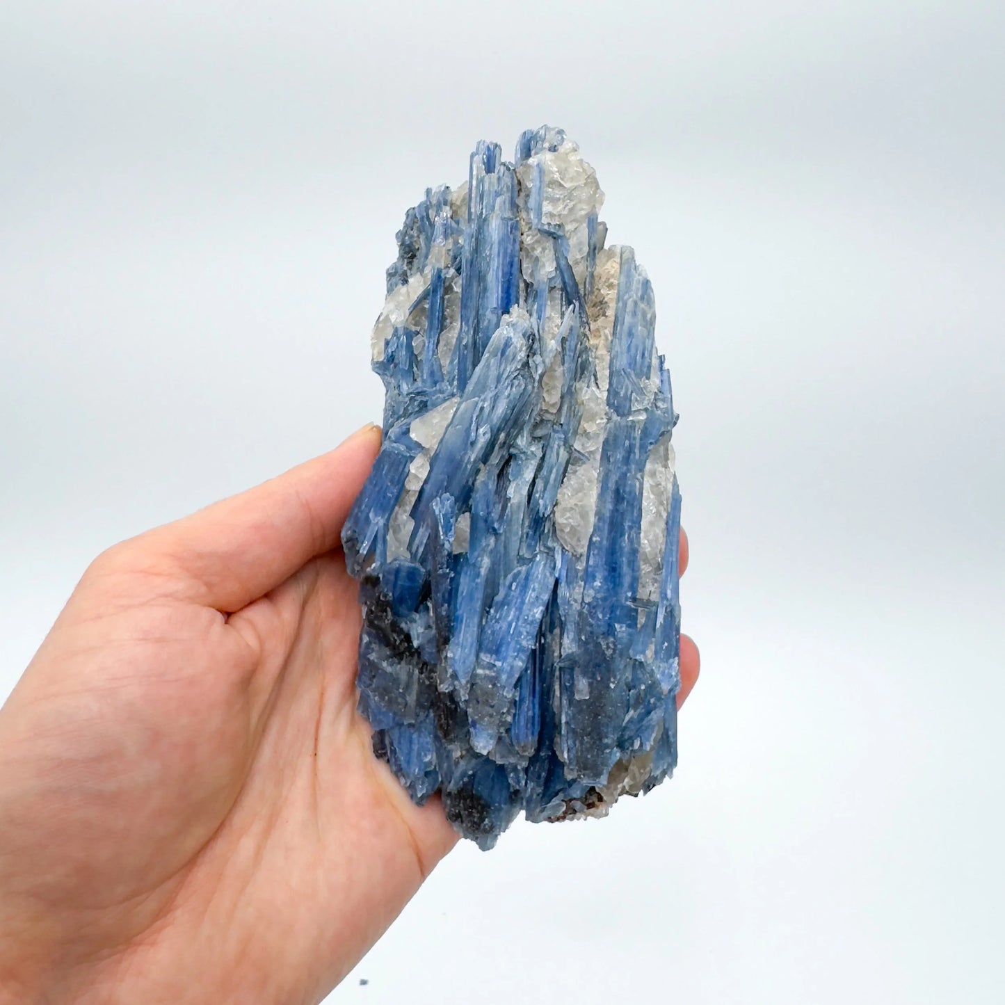 Studio-style view of Blue Kyanite specimen, set to give a sense of weight.