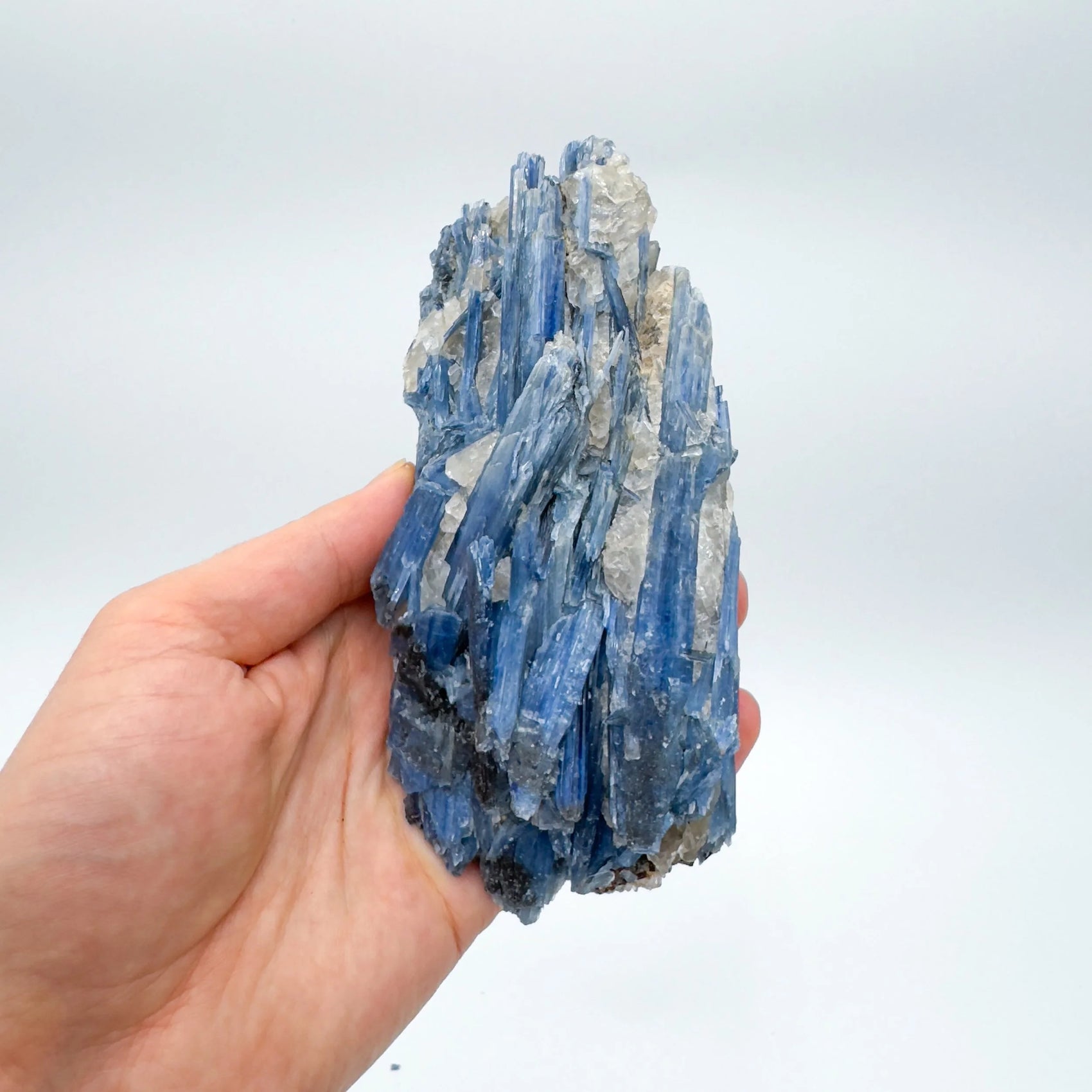 Studio-style view of Blue Kyanite specimen, set to give a sense of weight.