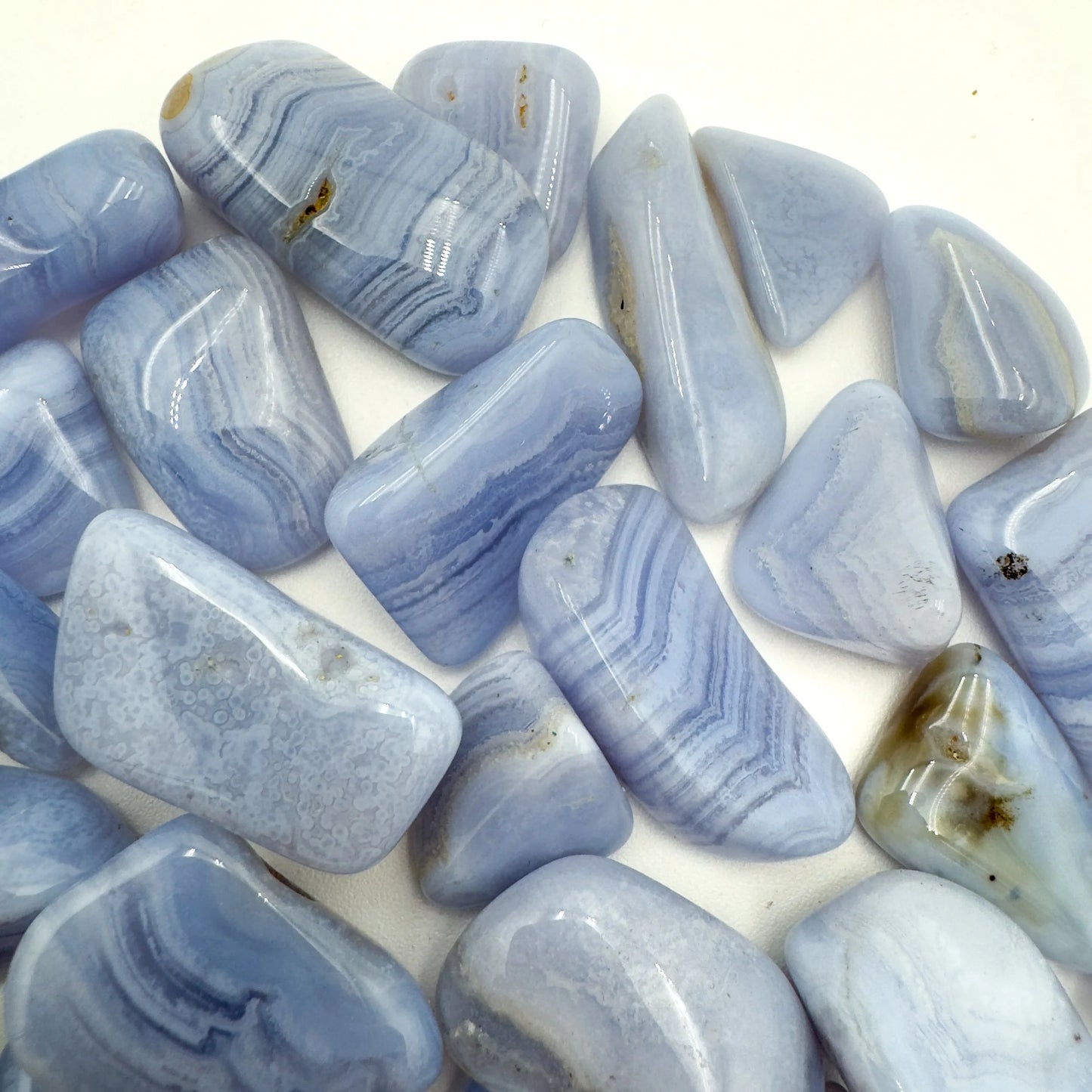 Three-quarter view of Blue Lace Agate tumbled stone, from ǁkaras Region, Namibia, with hand-sized presence.