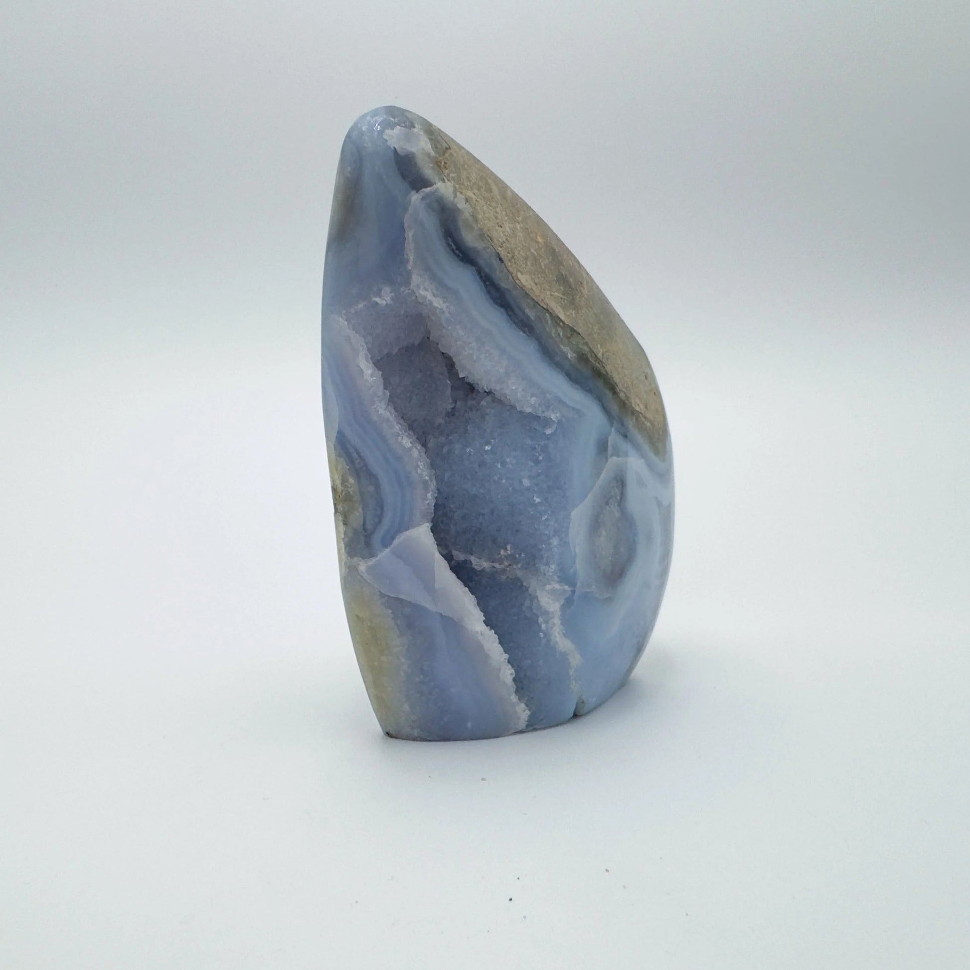 Edge view of Blue Lace Agate raw geode, drawn on for Stress Relief, showing natural banding.