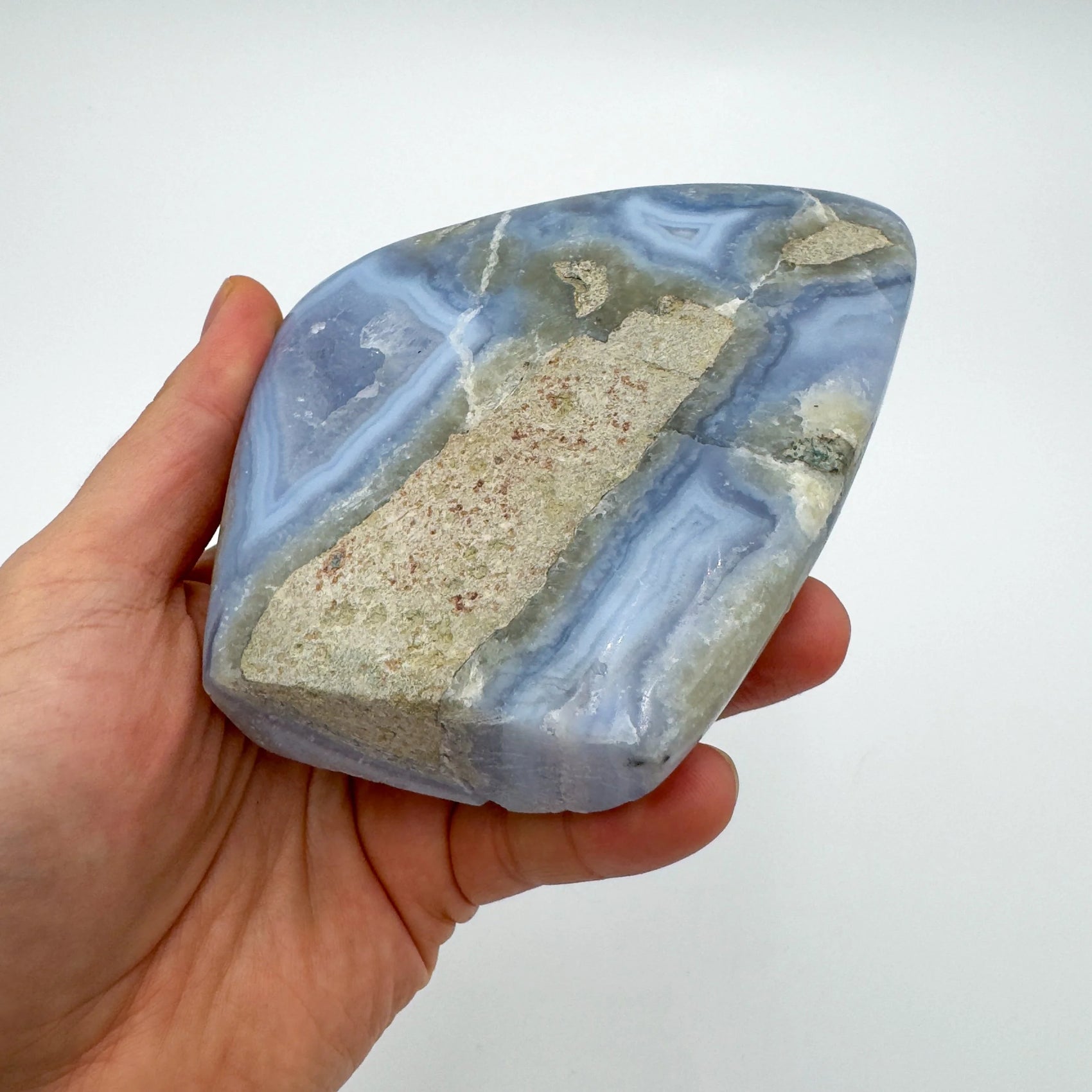 Detail shot of Grade AA Blue Lace Agate geode under natural light