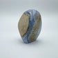 Opposite side of Grade AA Blue Lace Agate raw geode, showing natural banding, drawn on for Stress Relief and Emotional Healing.