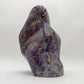 Open-palm view of Blue Rose Quartz stone, traditionally used for Confidence, shown at hand scale.