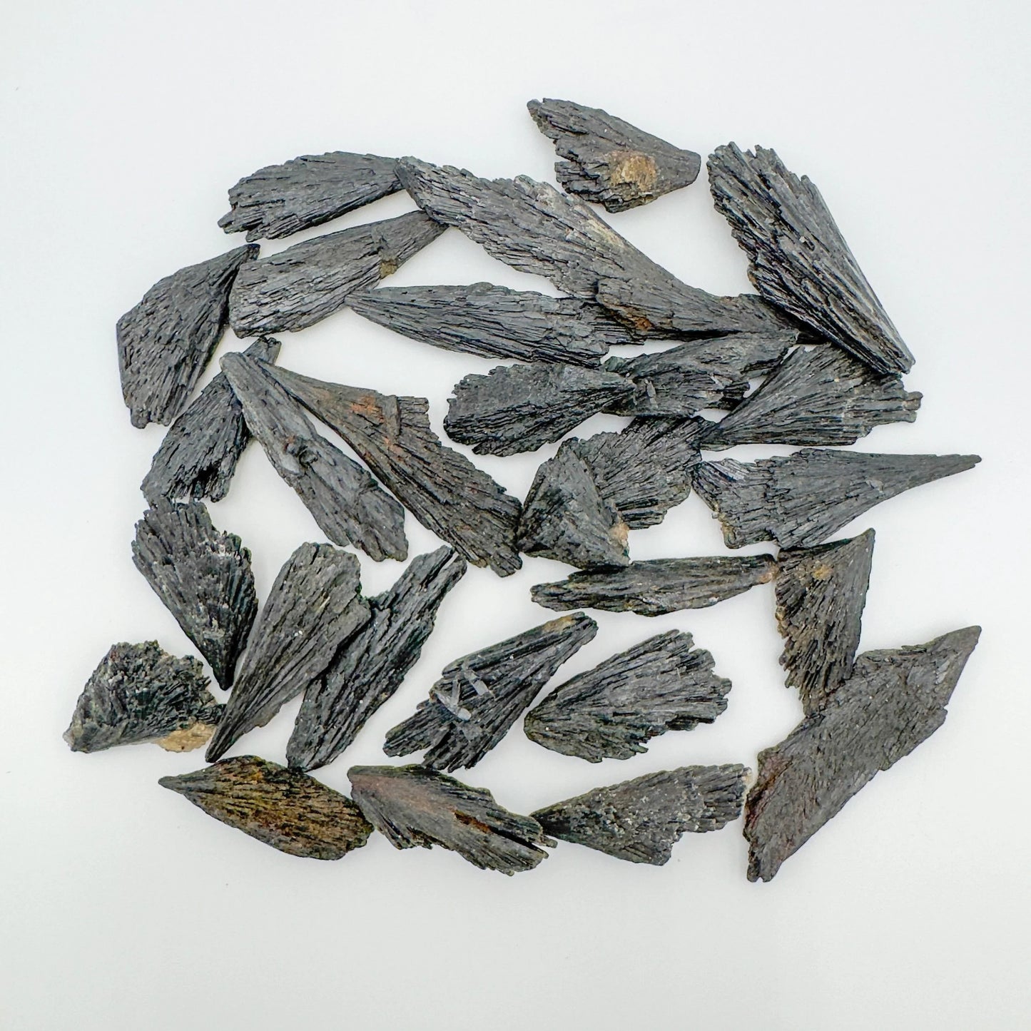 Texture-level view of Black Kyanite raw stone, showing open form, from Brazil.