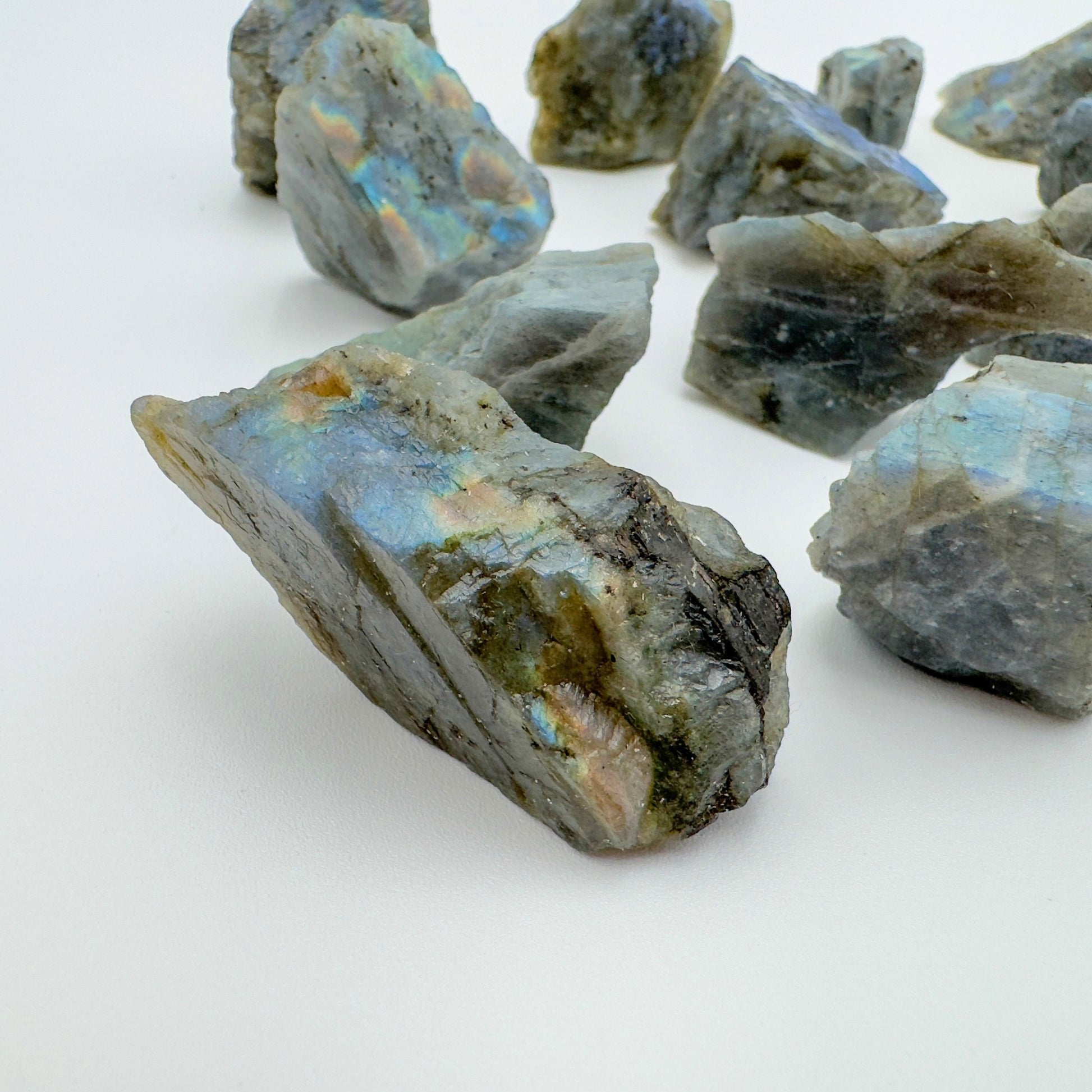 Side profile of Grade AA Labradorite raw stone, showing natural patina.