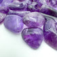 Lateral view of Amethyst tumbled stone, worked with for Stress Relief and Sleep.
