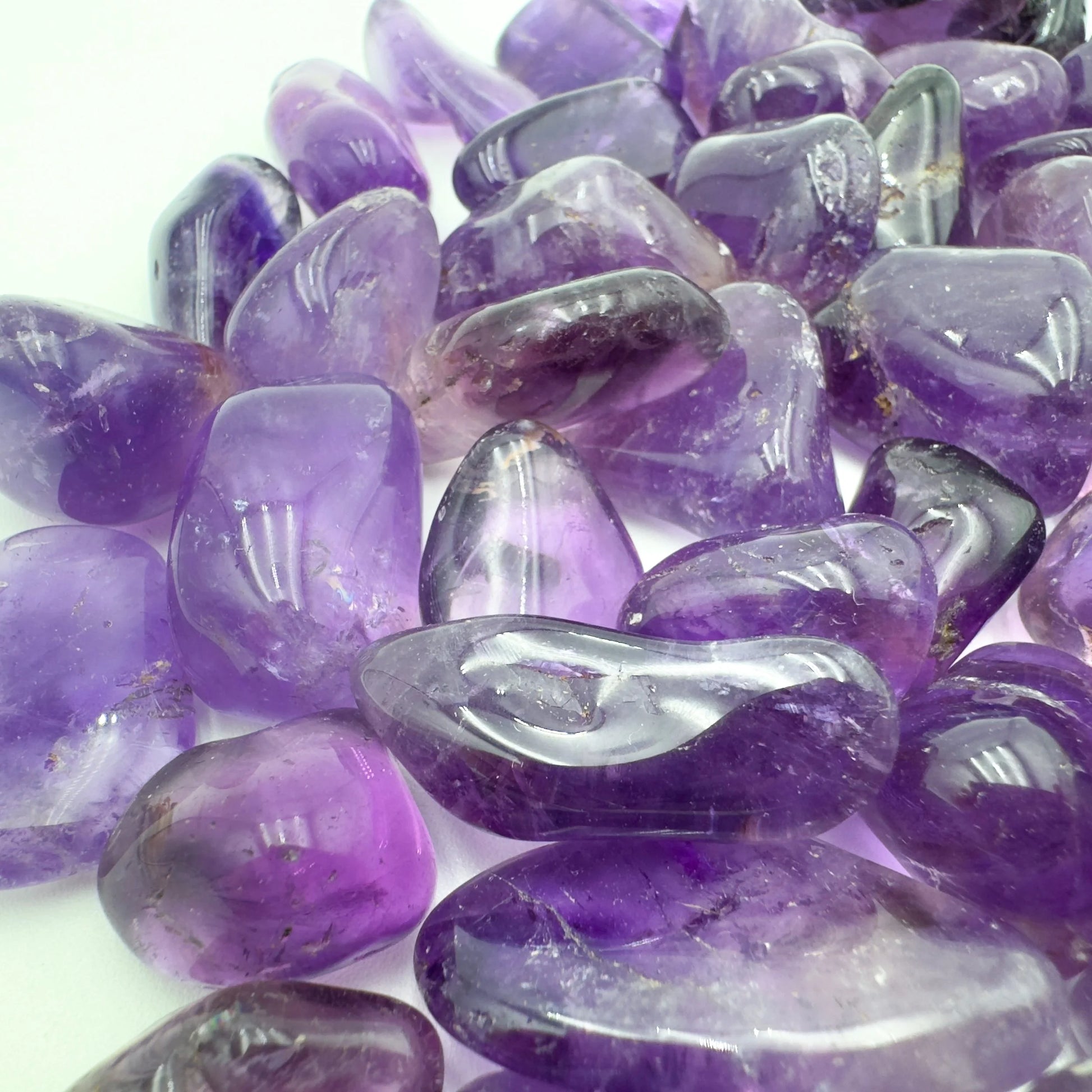 Top-down shot of Amethyst tumbled stone, showing characteristic color.