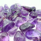 In-hand view of a Amethyst tumbled stone, from Brazil.