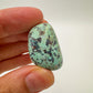 Back view of Grade A Chrysocolla tumbled stone showing natural surface