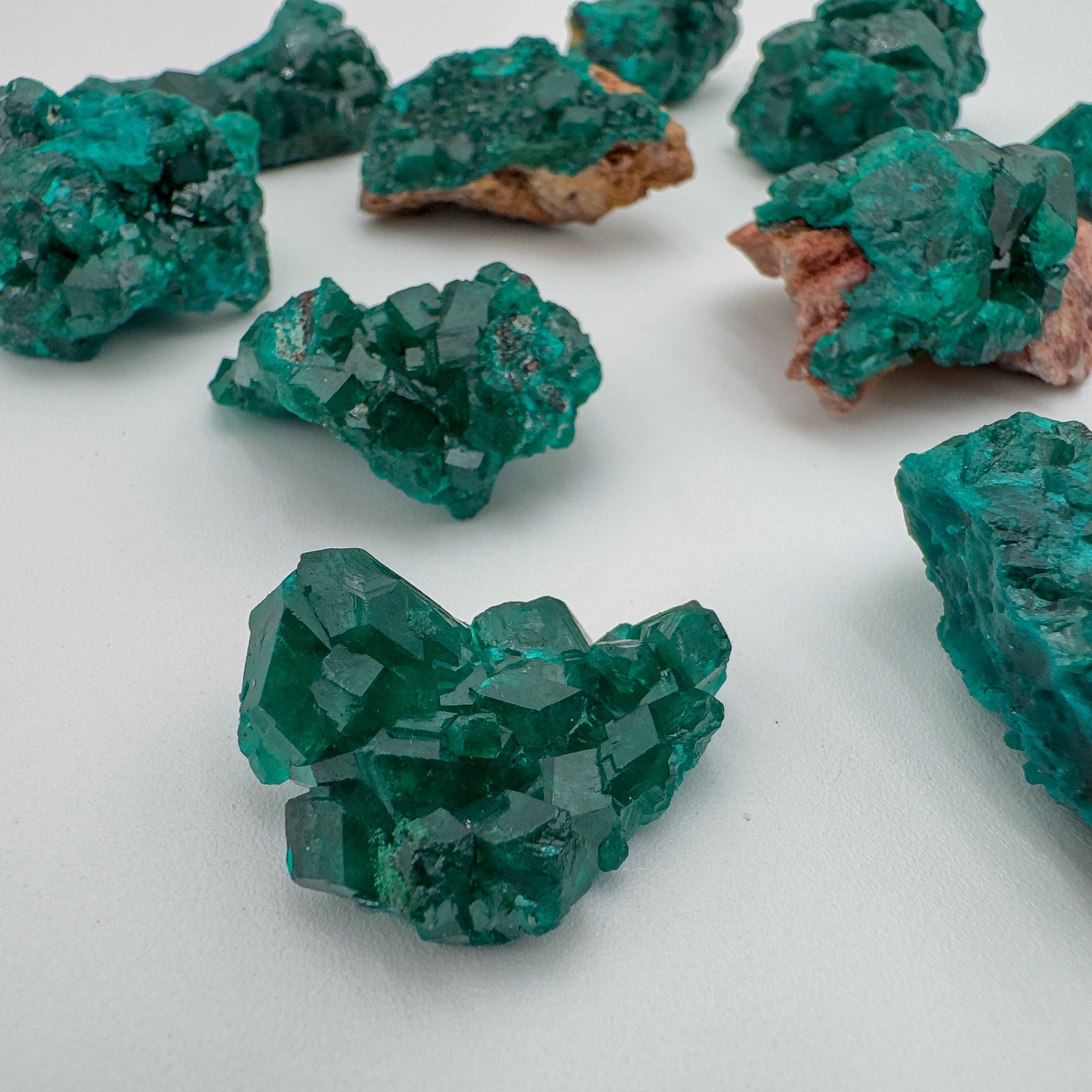 Looking down on green Dioptase raw stone, showing natural patina, from Republic of the Congo.