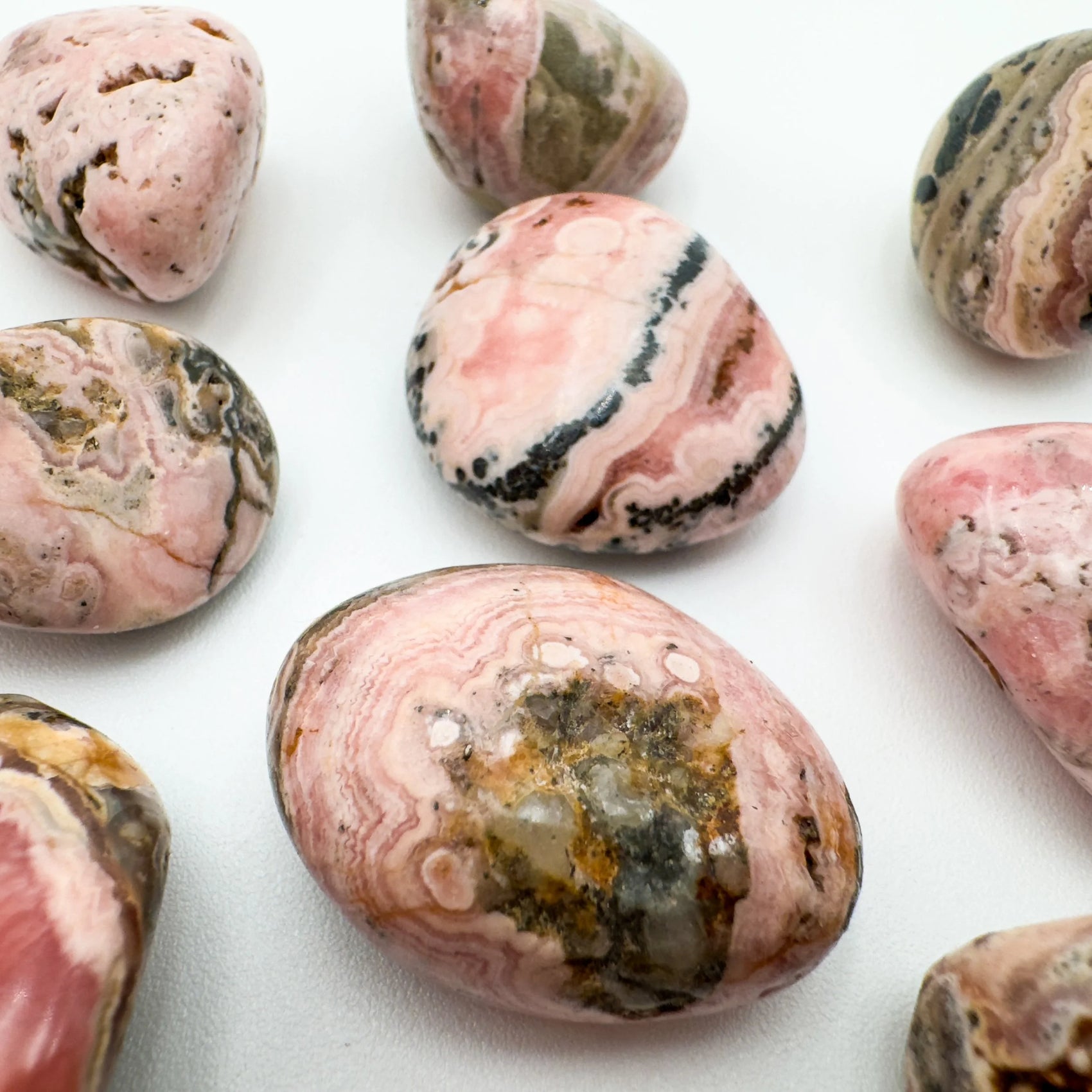 Back view of Grade A Rhodochrosite tumbled stone showing natural surface