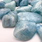 Overhead view of Aquamarine tumbled stone, often worked with for Stress Relief, Brazil-sourced.