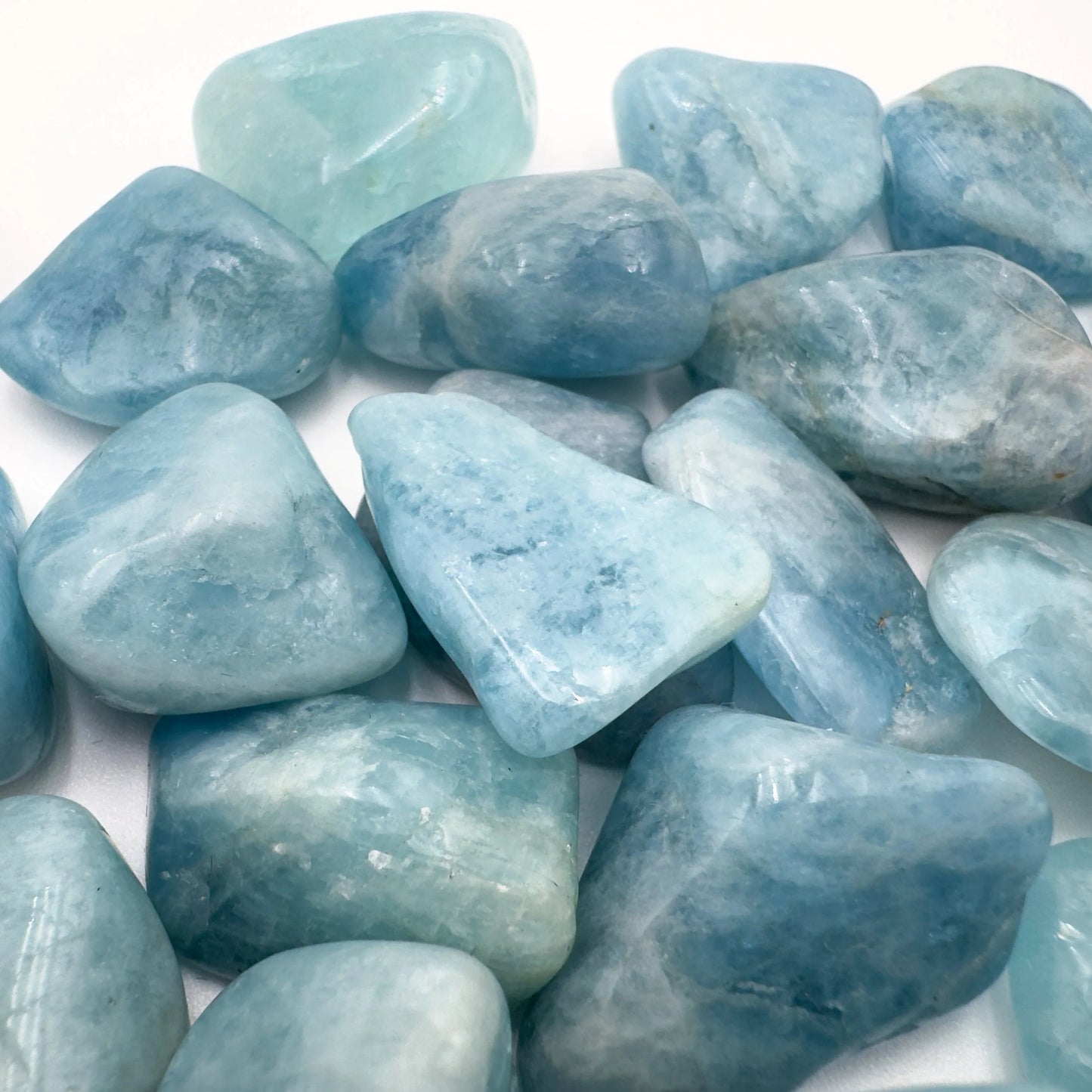 Back view of Grade AAA Aquamarine tumbled stone showing natural surface