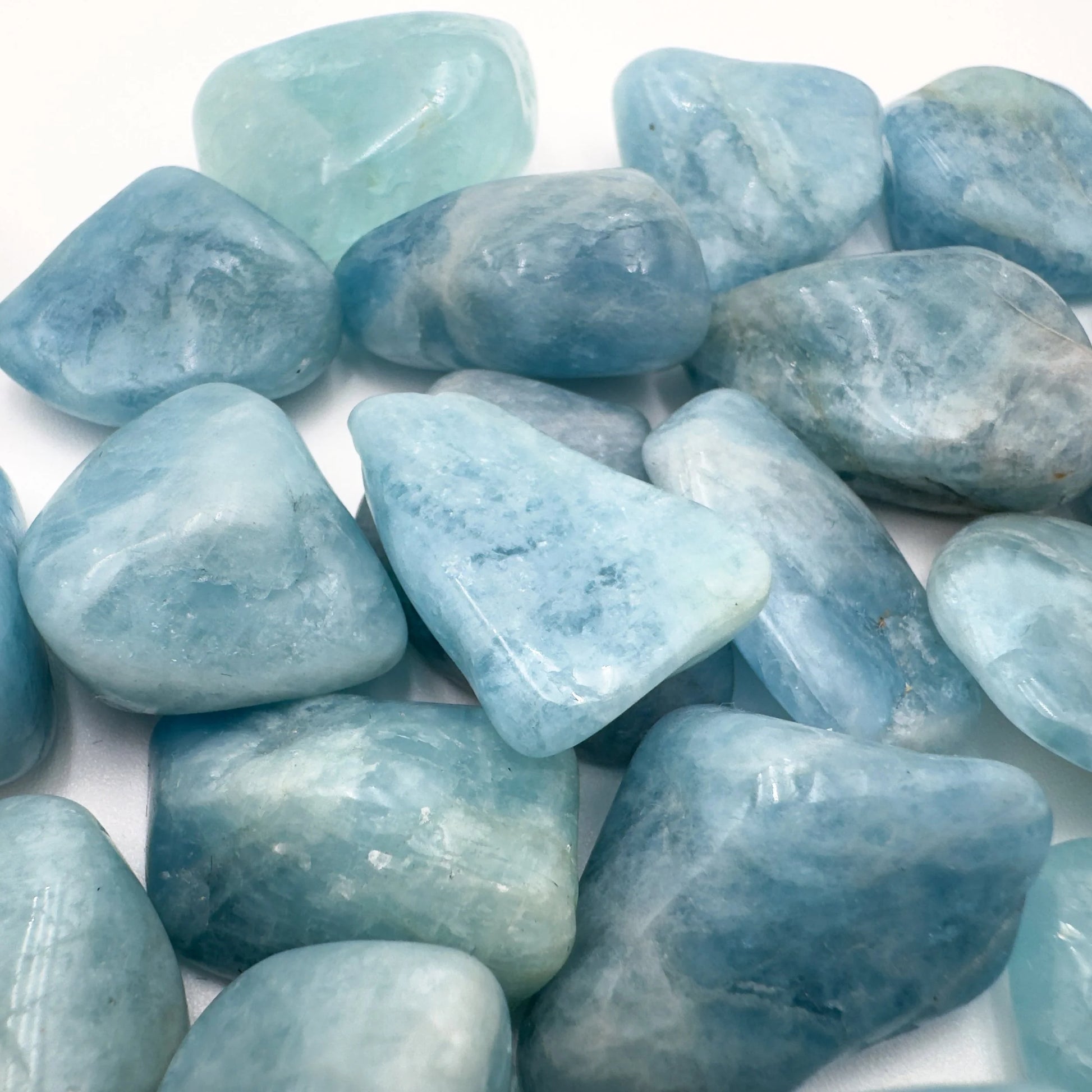 Back view of Grade AAA Aquamarine tumbled stone showing natural surface