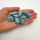 Detail shot of Grade AAA Aquamarine tumbled stone under natural light