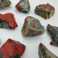 Grade aa bloodstone raw held in hand for size reference