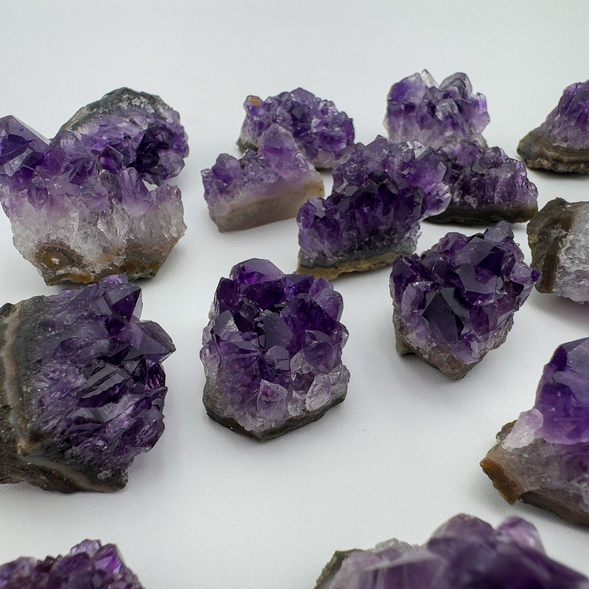 Grade aa amethyst cluster held in hand for size reference