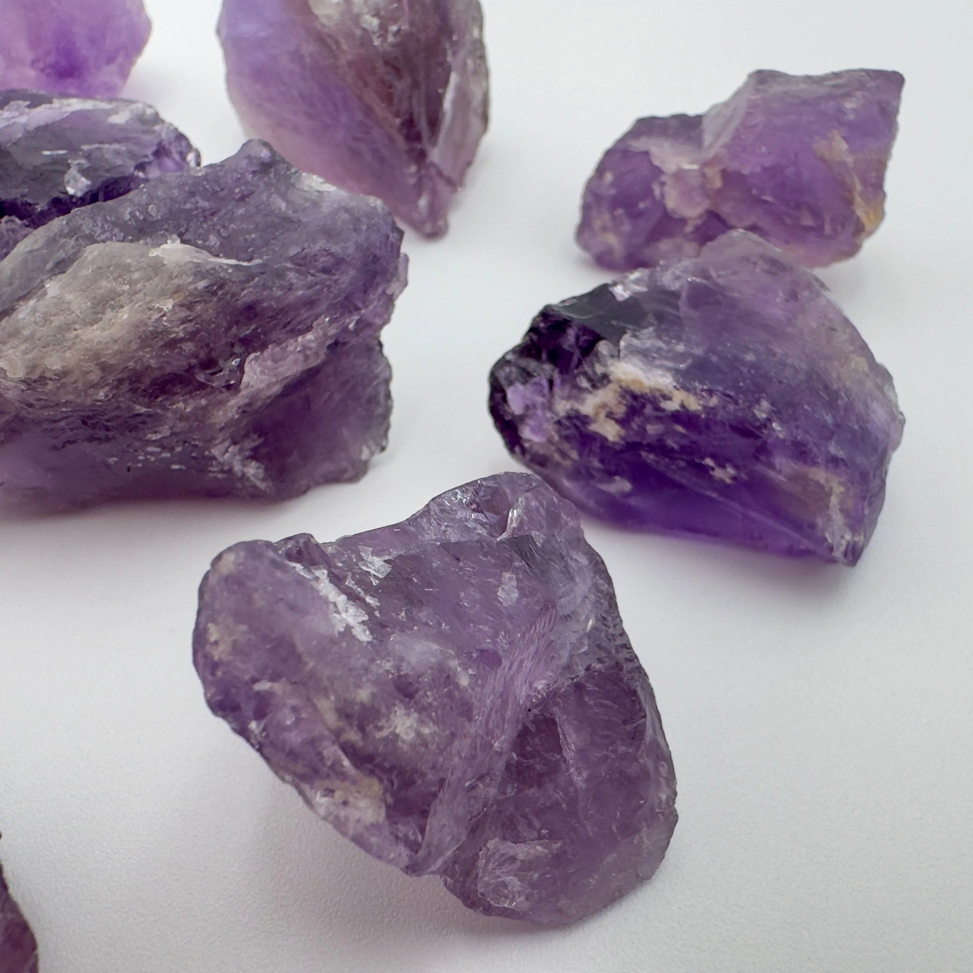In-hand view of a Amethyst raw stone, sourced from Brazil.