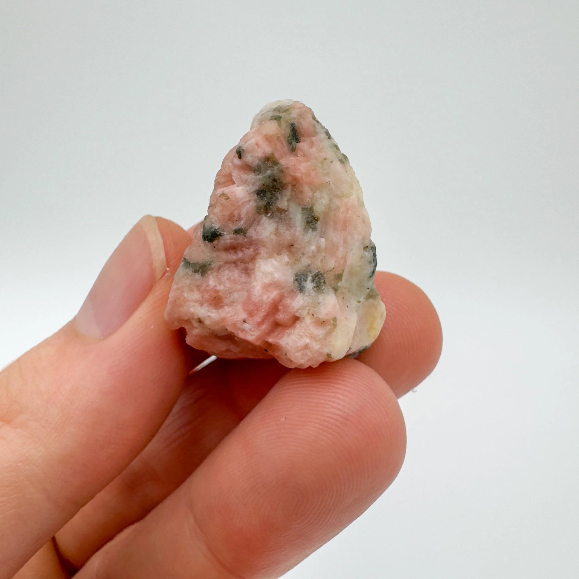 Soft-light view of Orange Calcite raw crystal, linked to Energy, with form visible in context.