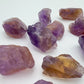 Grade aa ametrine raw held in hand for size reference
