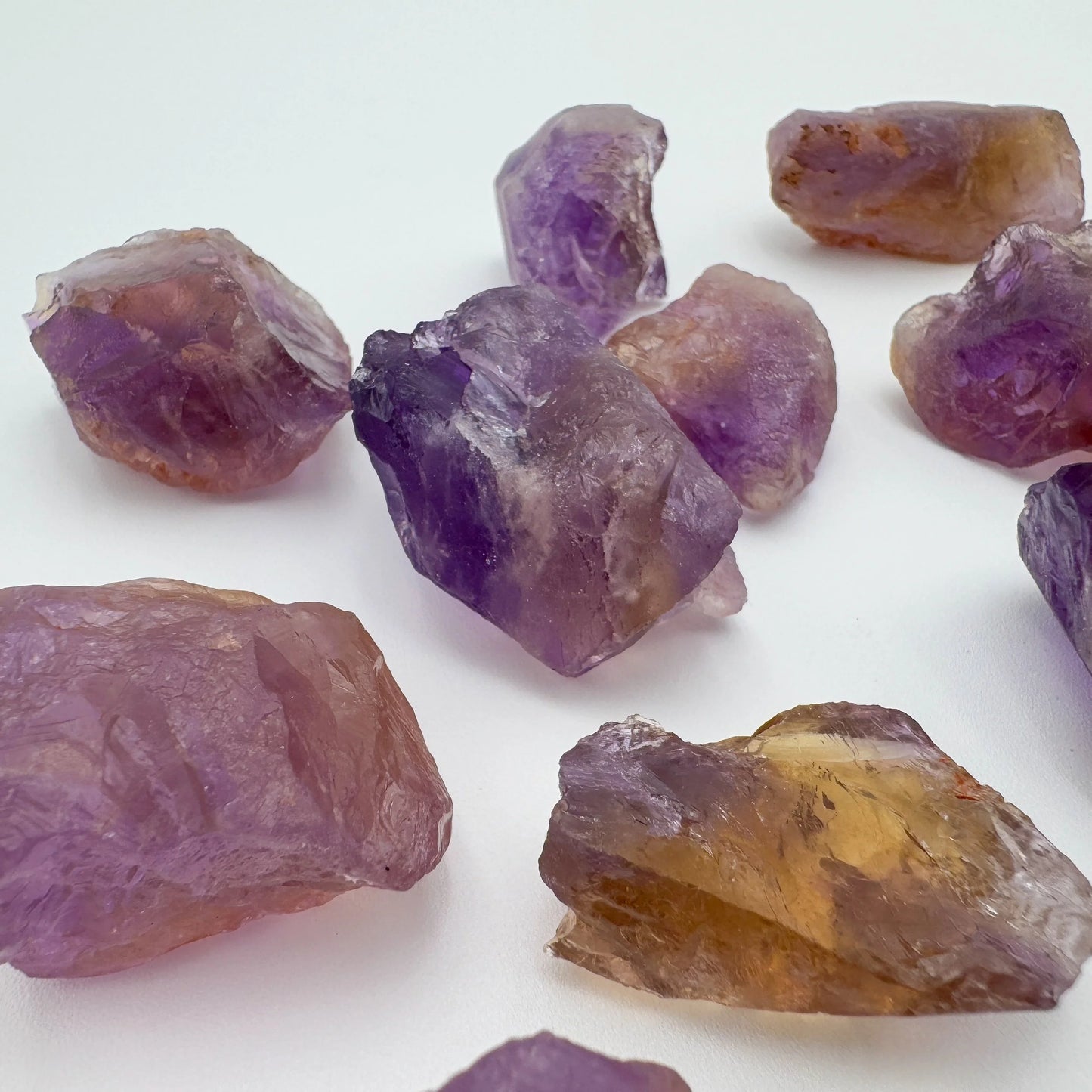 Grade aa ametrine raw held in hand for size reference