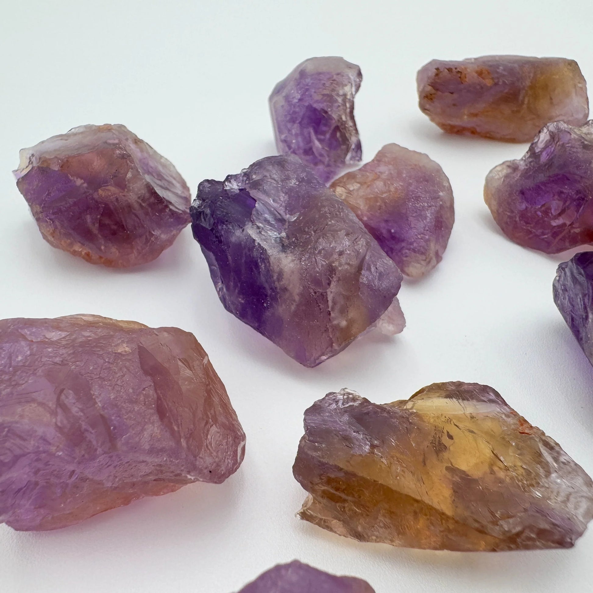 Grade aa ametrine raw held in hand for size reference