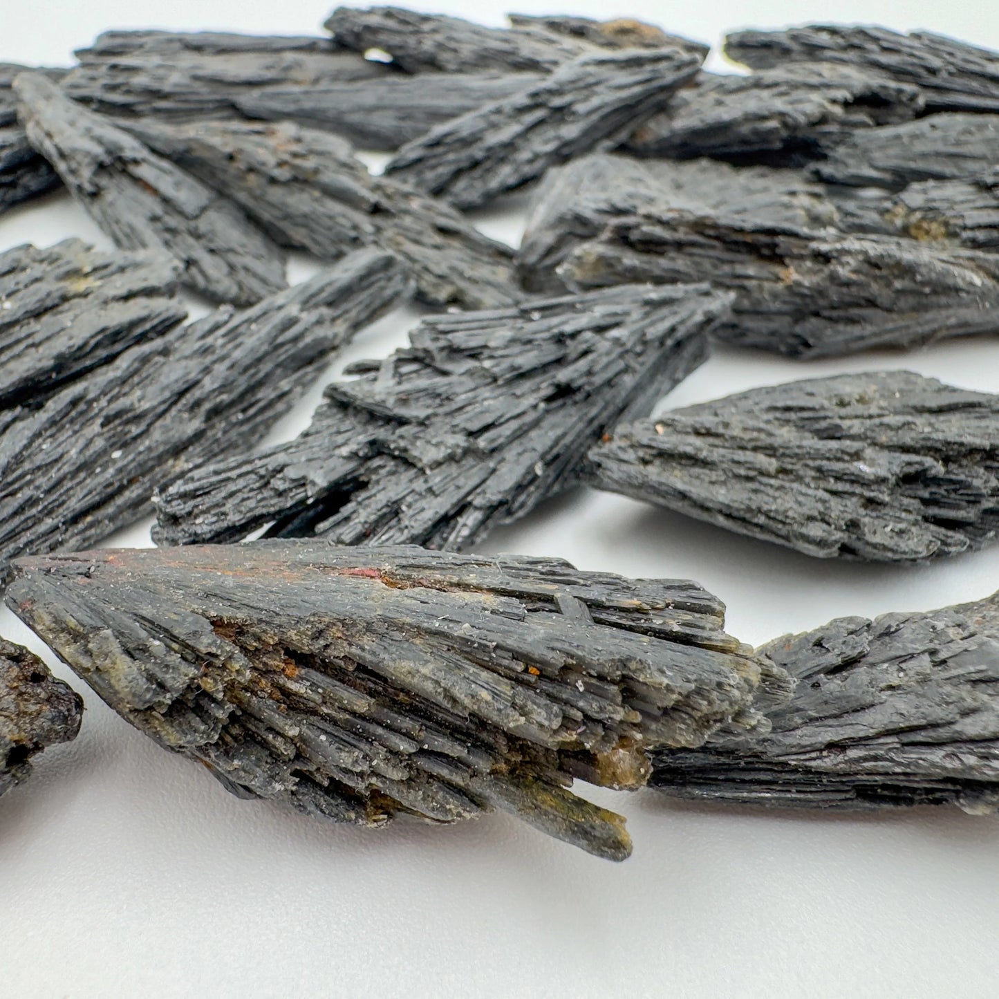 Side-on view of Black Kyanite raw stone, showing natural sheen, from Minas Gerais, Brazil.