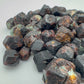 Side angle of Fuchsite raw stone, showing characteristic patterning.