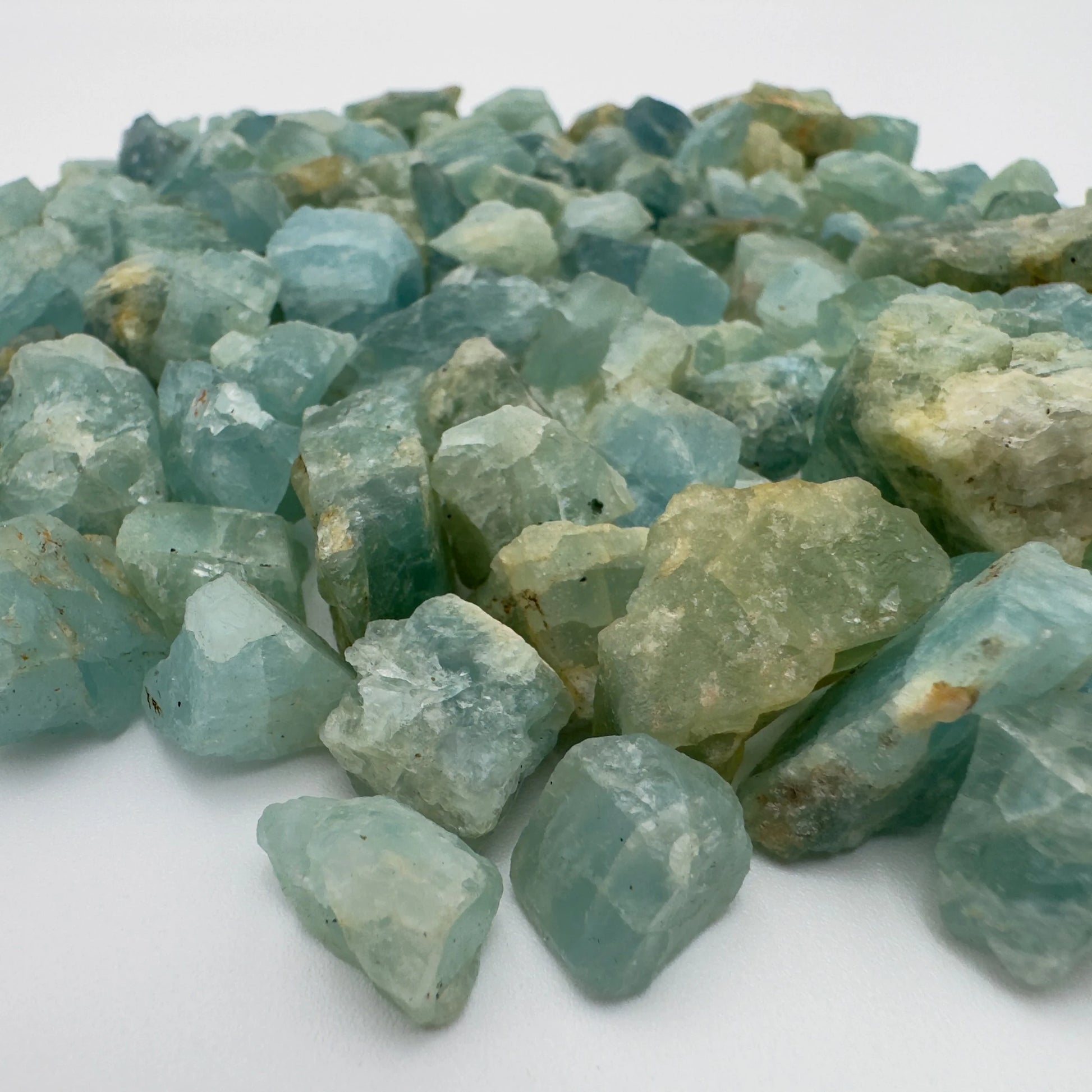 Edge view of Aquamarine raw stone, showing natural form, hand-selected from Huíla Province, Angola.