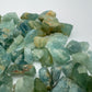 Grade a aquamarine raw held in hand for size reference