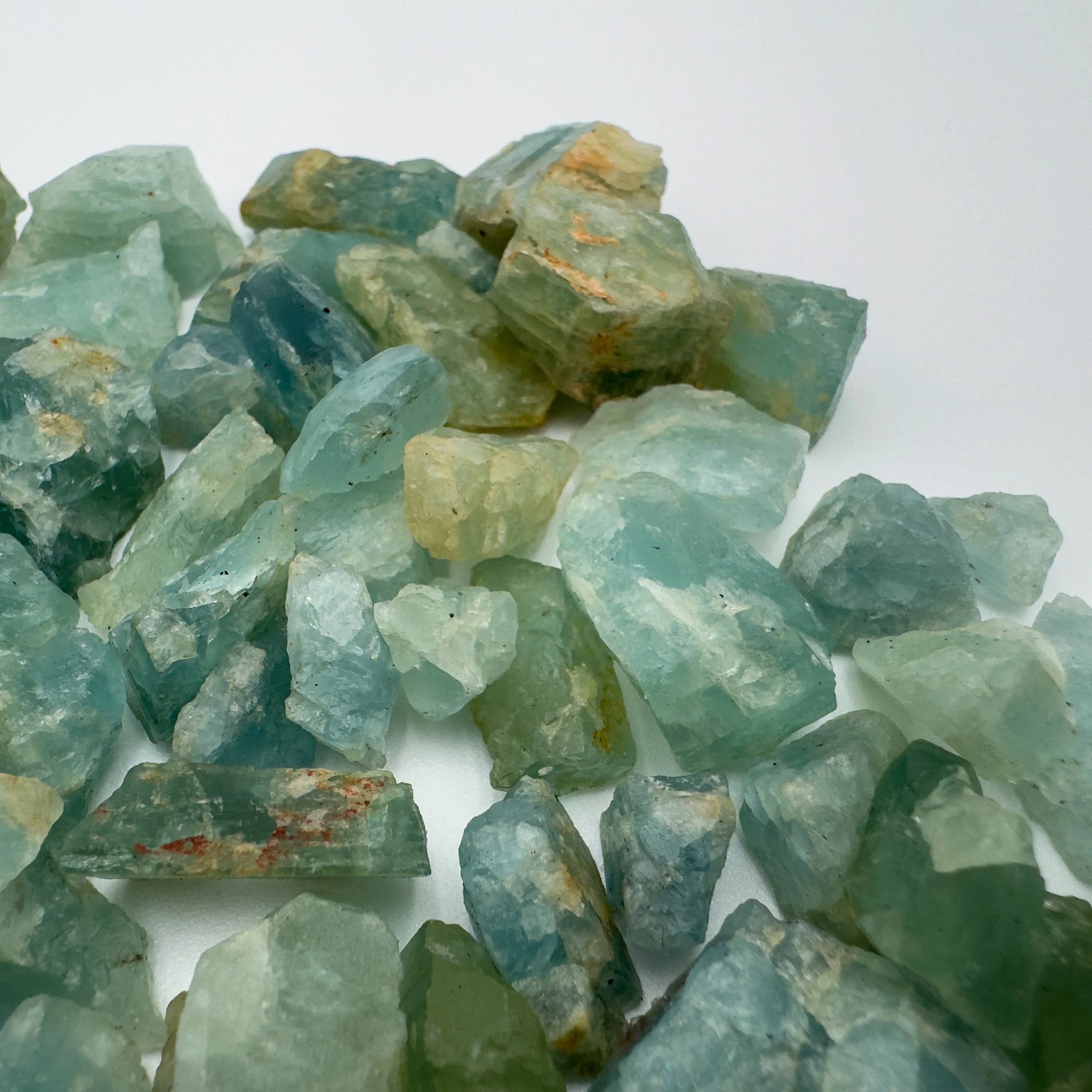 Grade a aquamarine raw held in hand for size reference