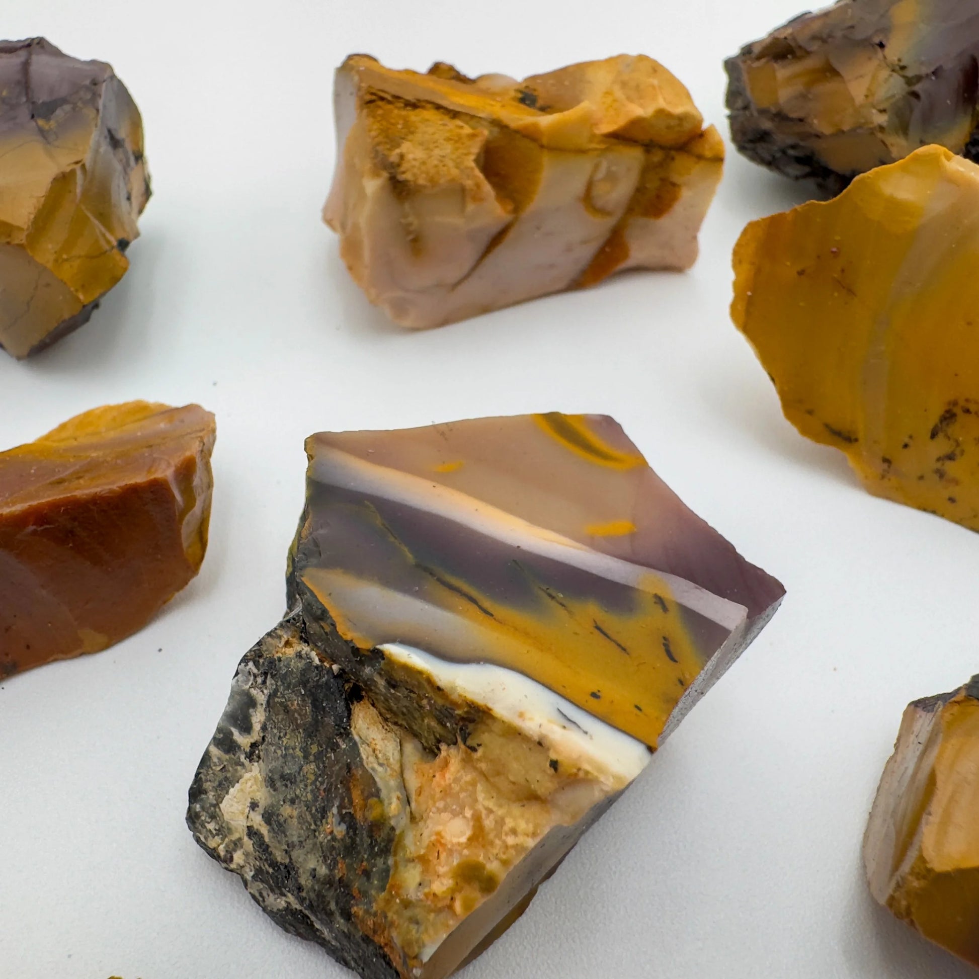 Top-down shot of Mookaite raw stone, sourced from Western Australia, Australia, linked to Grounding and Adventure.