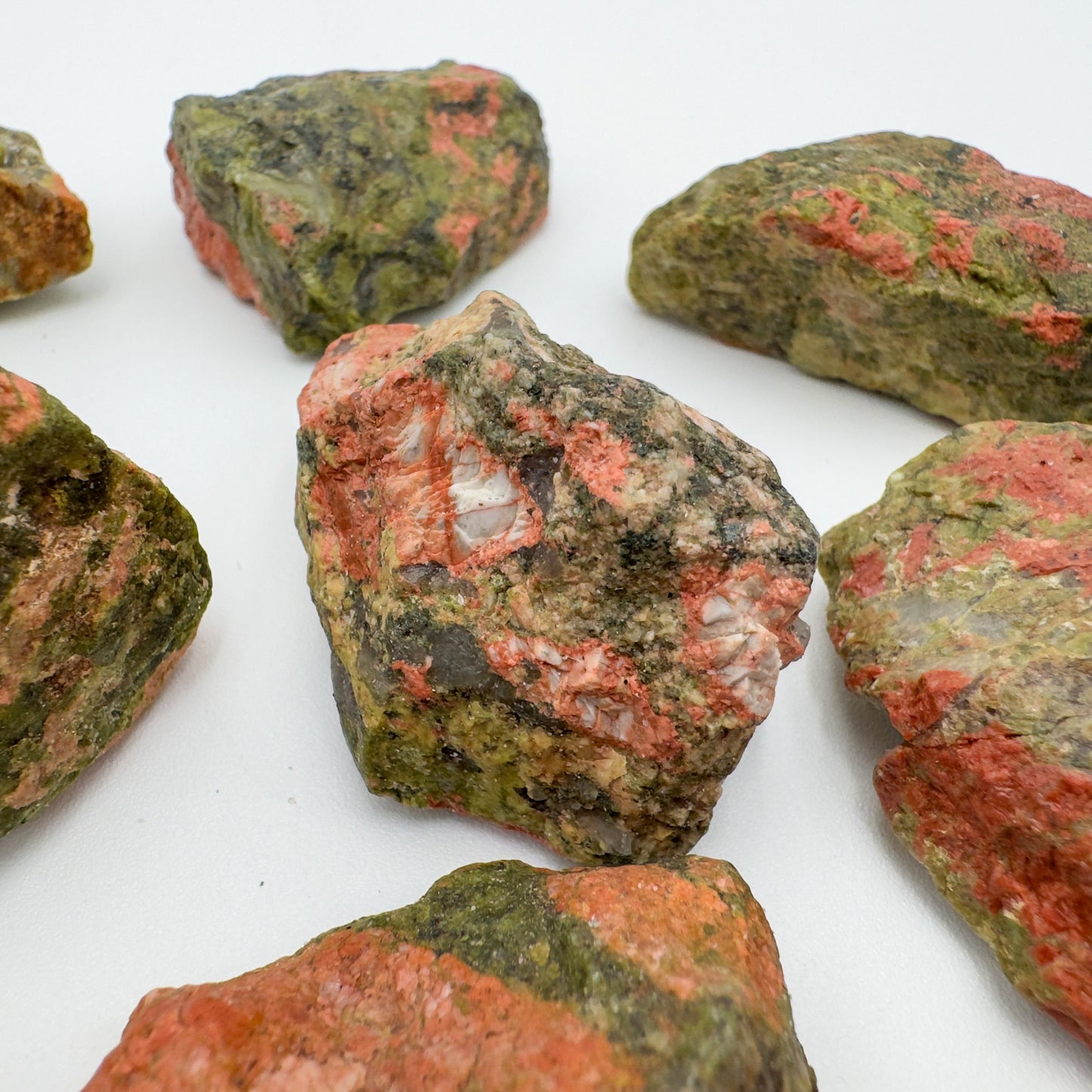 Held in hand, a Unakite raw stone, hand-selected from Northern Cape, South Africa.