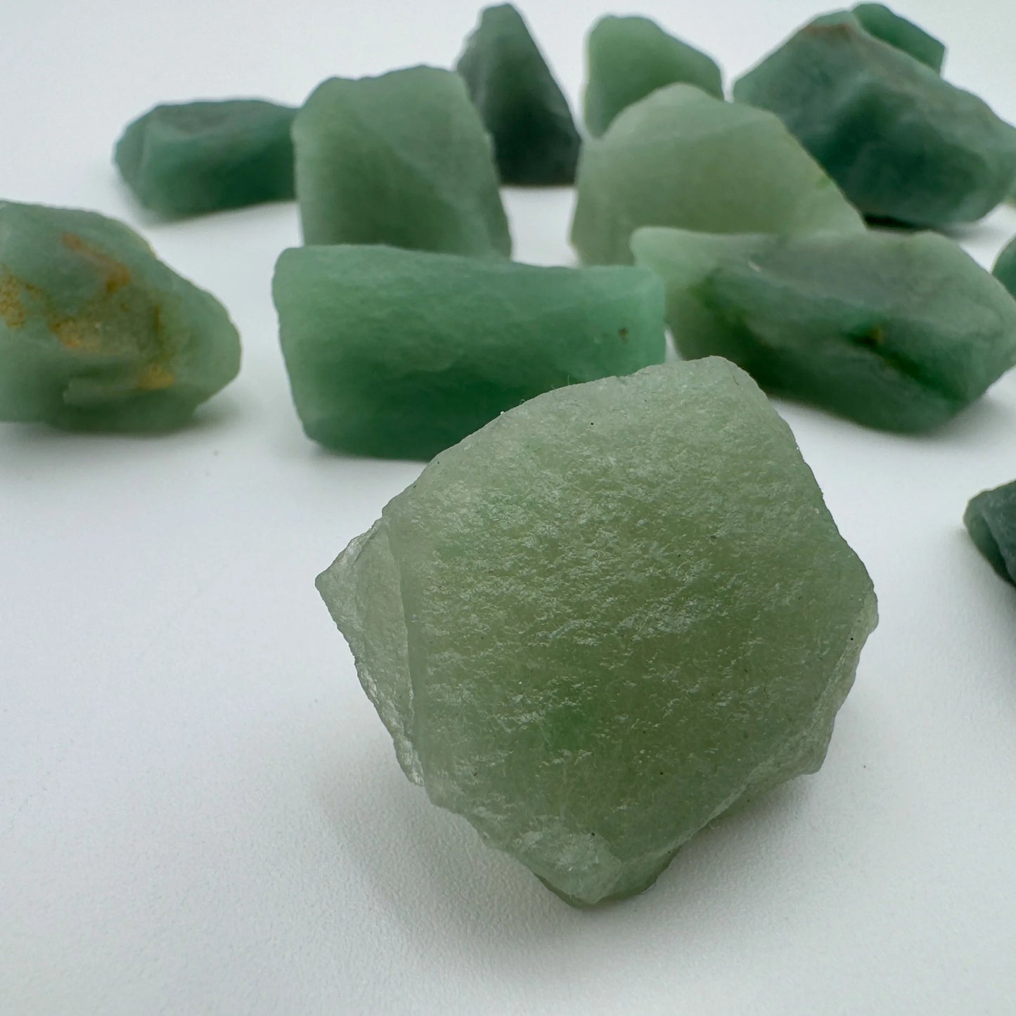 Lateral view of Aventurine raw stone, Brazil-sourced, showing characteristic color.