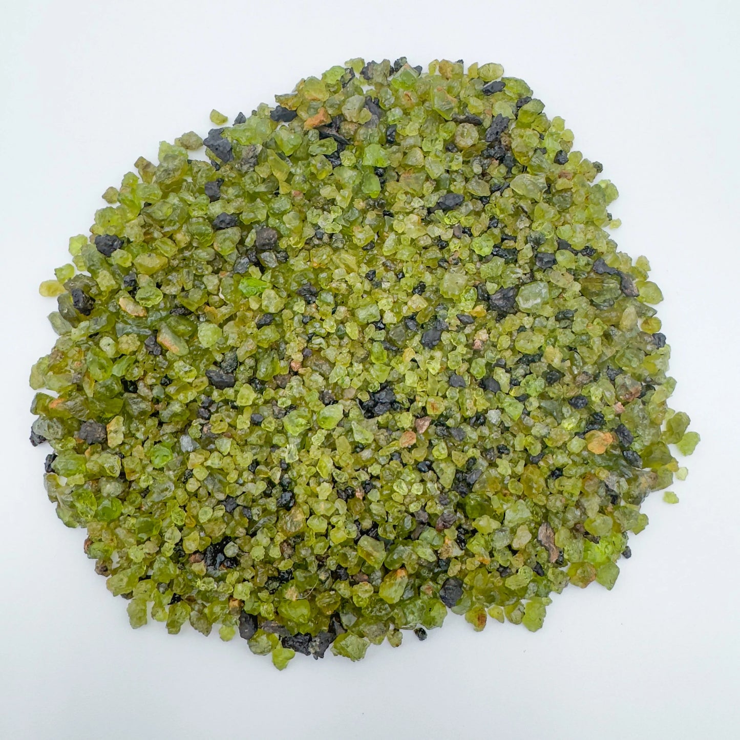 Side profile of Grade AA Peridot raw with natural form and inclusions