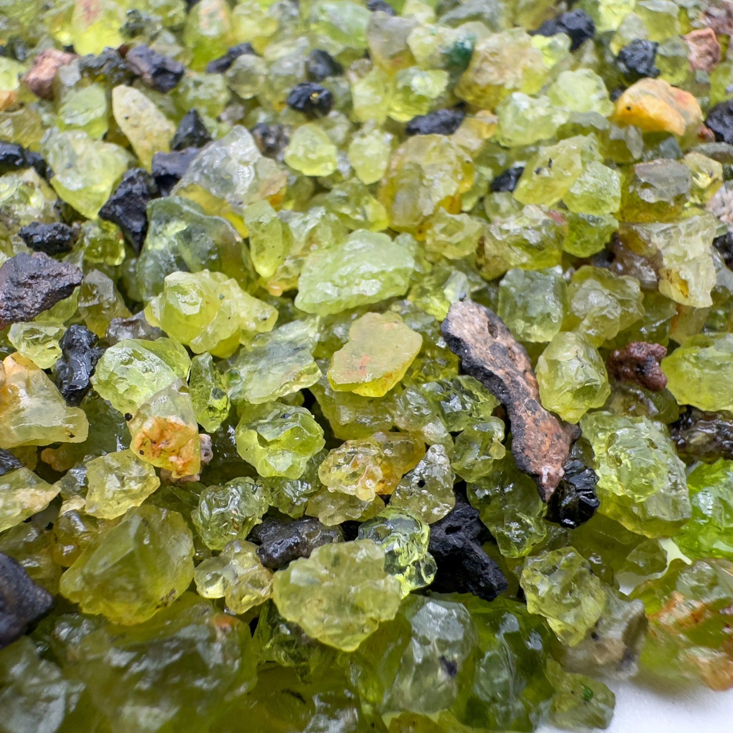 Alternate angle of Grade AA Peridot raw showing overall shape
