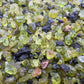 Grade aa peridot raw held in hand for size reference