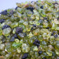 Back view of Grade AA Peridot raw showing natural surface