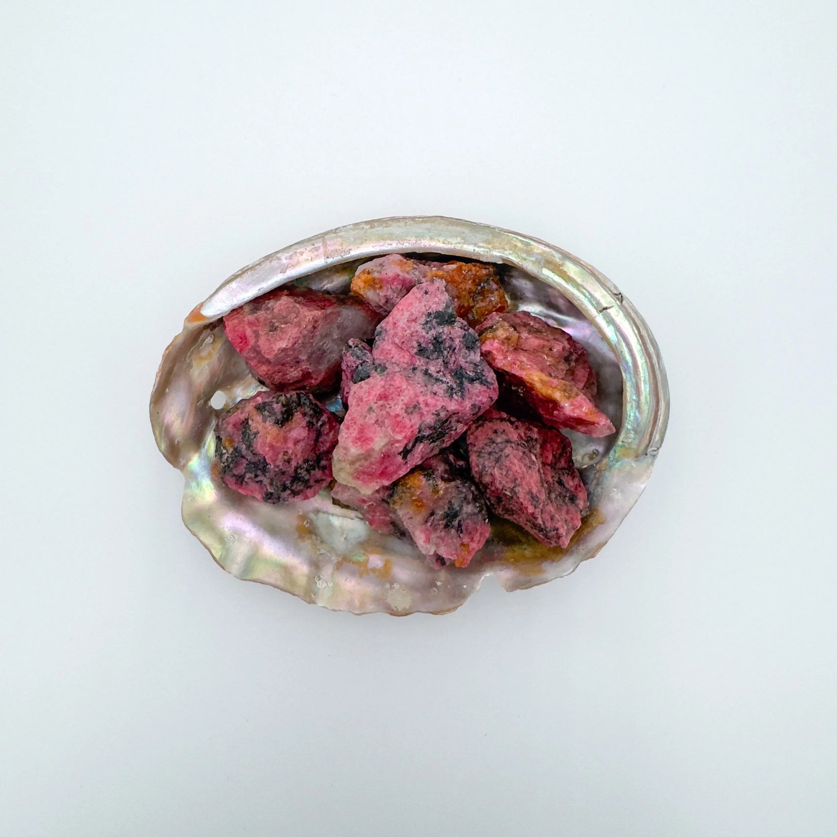 Rhodonite raw stone in Pink, Black tones, ethically sourced from Zimbabwe for Emotional Healing and Love