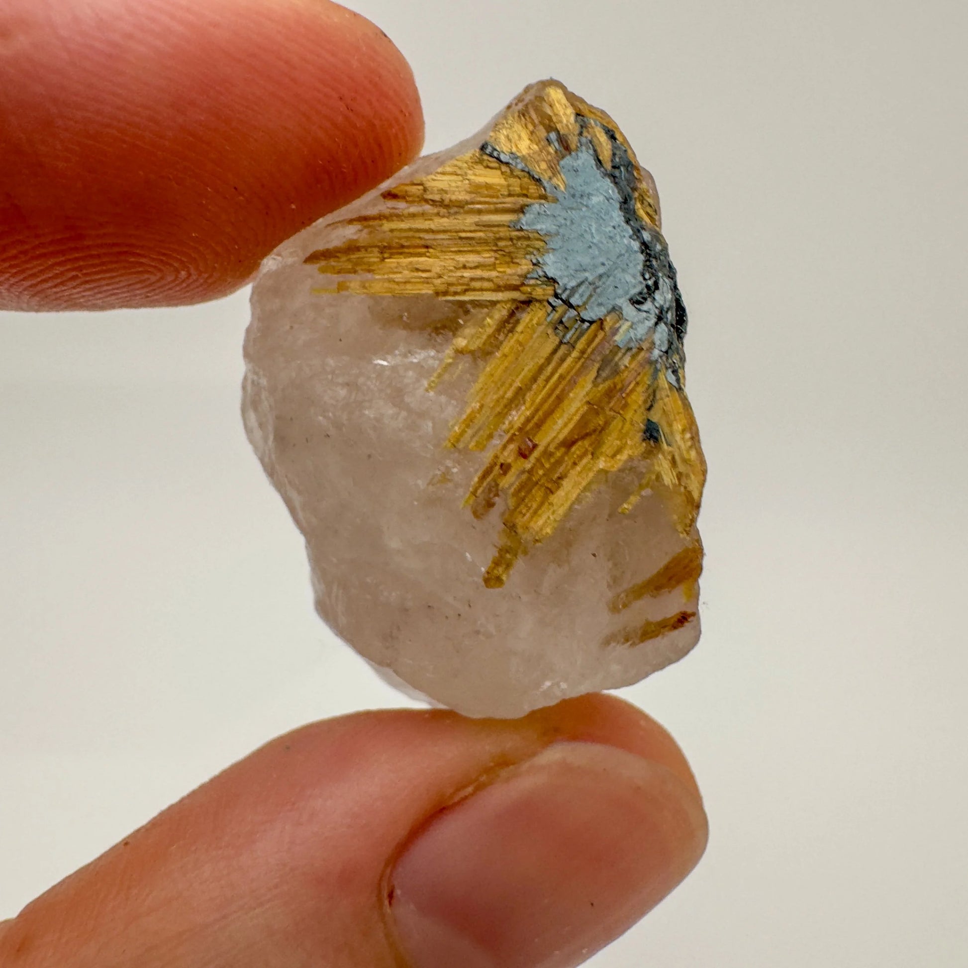 Set against a soft backdrop is a Quartz raw crystal, from Minas Gerais, Brazil, in the warmth of daylight.