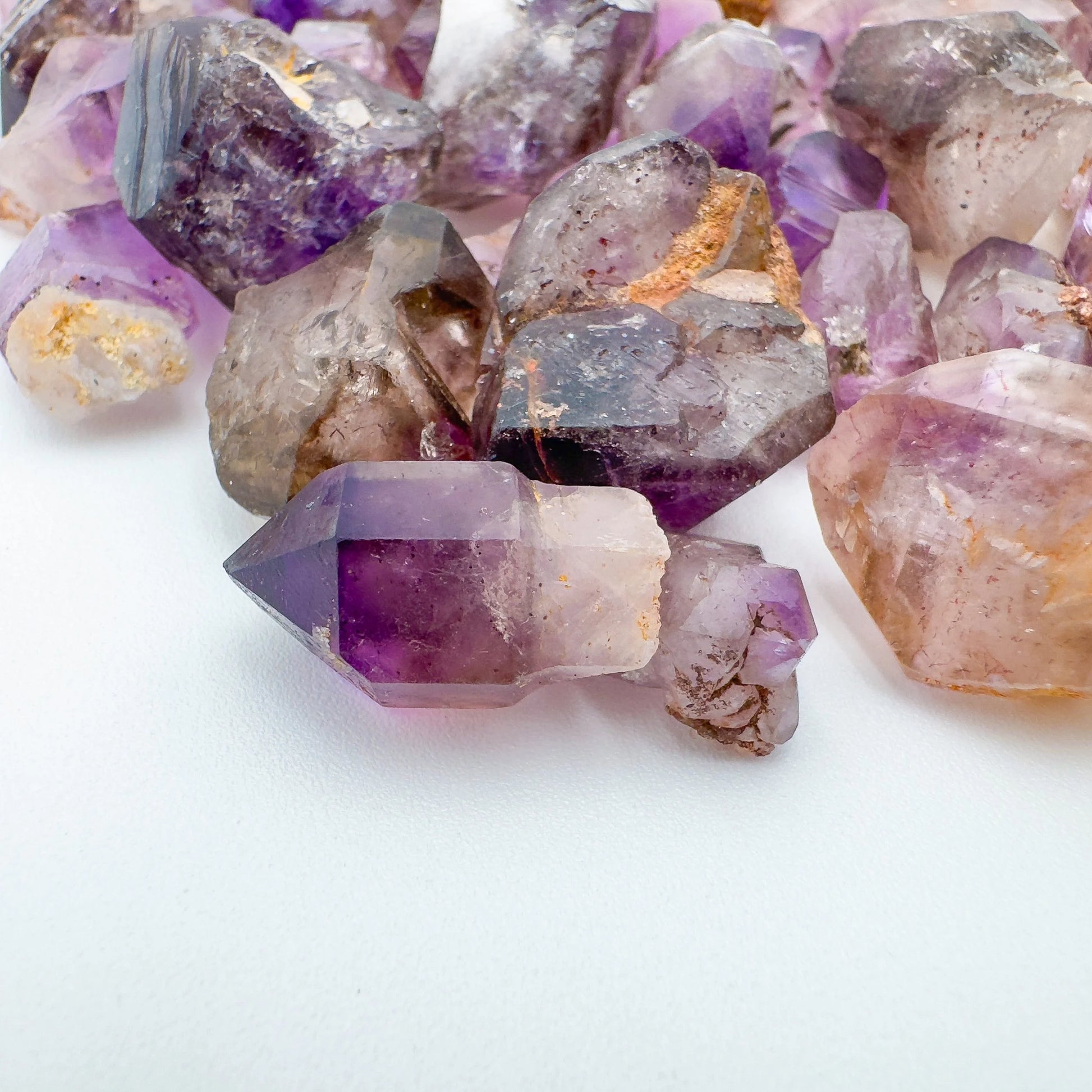 Top view of Smoky Amethyst raw point, showing natural sheen.