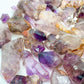 Size comparison with one Smoky Amethyst raw point for scale, Zimbabwe-sourced.