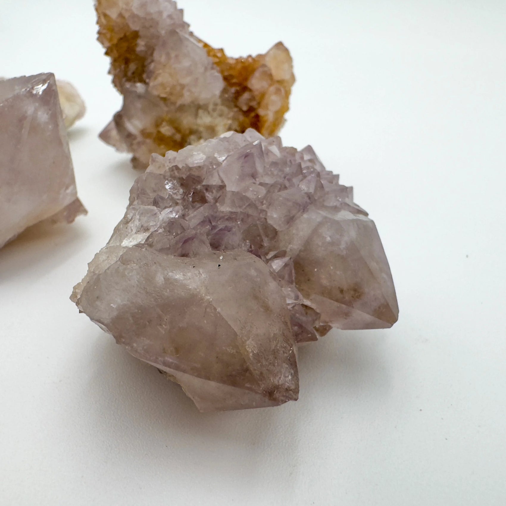 Hand-scale shot of a Quartz raw stone held against natural backdrop, South Africa-sourced.