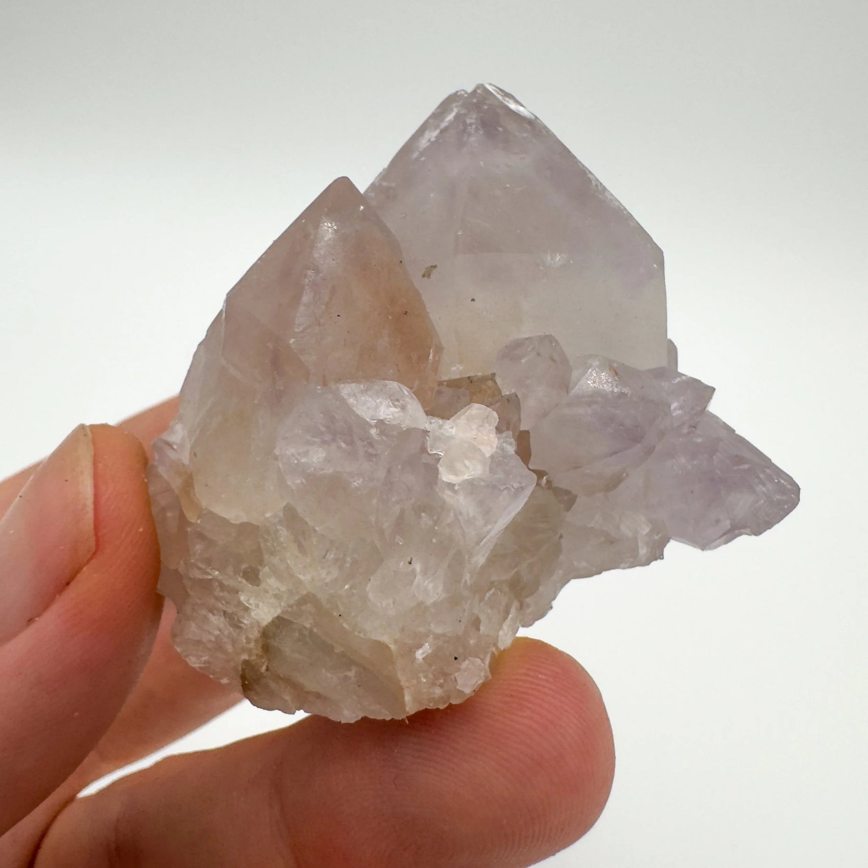 Grade aa quartz raw held in hand for size reference