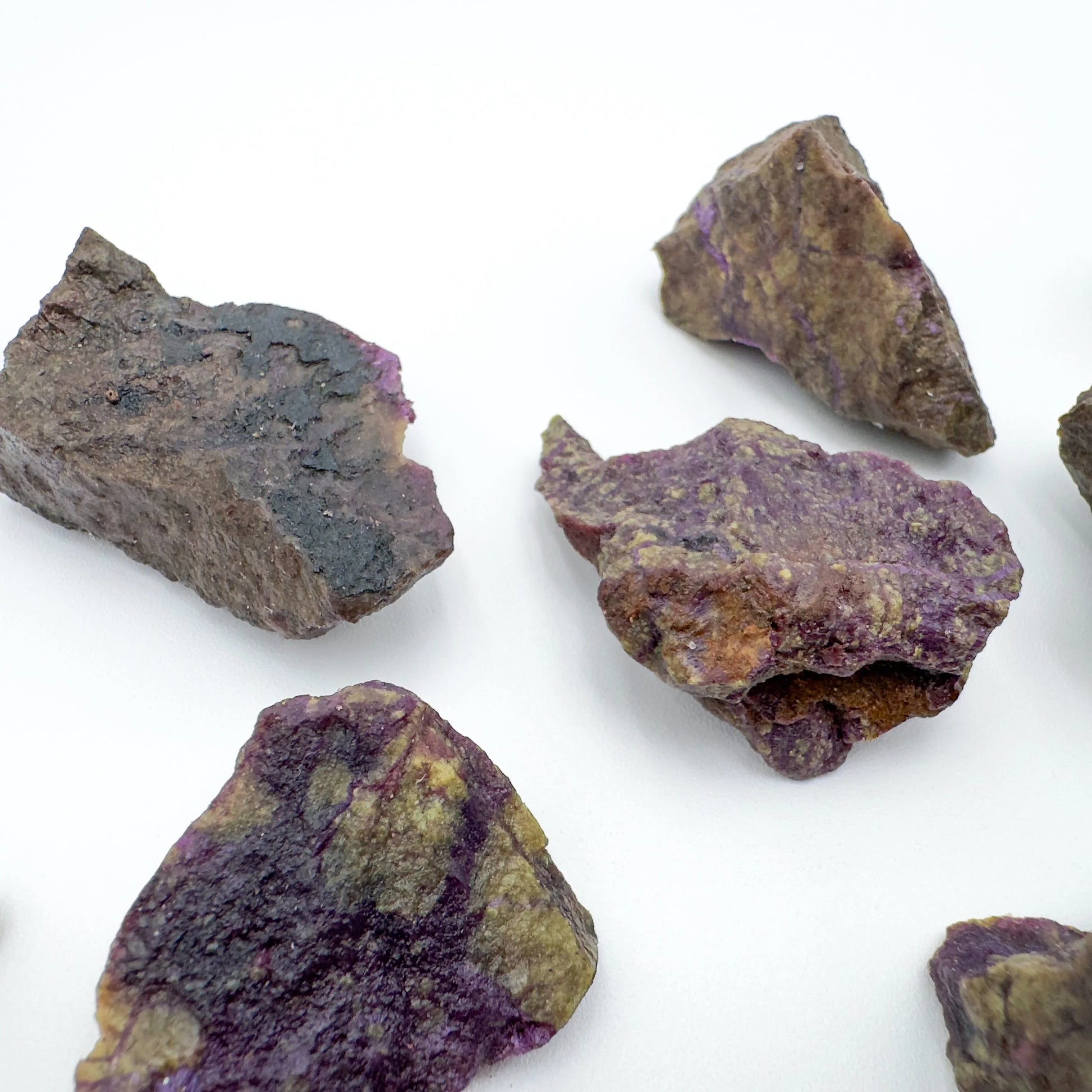 Daylight detail of Stichtite raw crystal, from Mpumalanga, South Africa, linked to Healing, shown for proportion against the hand.